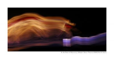 At the Point of Discovery. Photo by David Jouris, 2014. Blurred dancer across dark stage.
