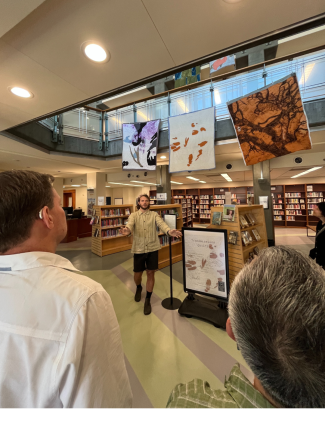Artist speaking in front of quilts