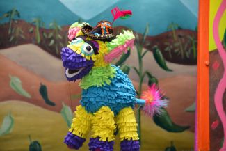 photo of a puppet shaped like a donkey pinata with a hat on