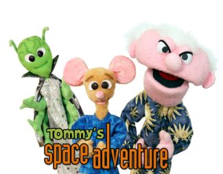 photo of green alien puppet, mouse puppet wearing blue shirt, and mad scientist puppet with white hair on his head