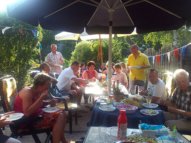 A family enjoying eating outdoors