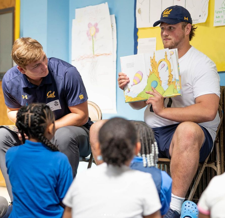 Cal Bears Read football players reading to children in a classroom