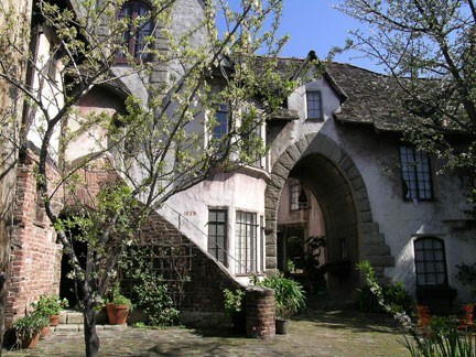 Exterior of Normandy Village, a fancy stone apartment complex.