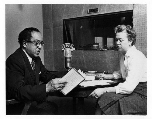 Langston Hughes (left) with Eleanor McKinney (right) in the KPFA radio studio, Berkeley, for "KPFA on-the-air," 1958.