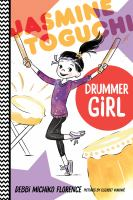 Child with black hair in a pony tail holding up two drum sticks standing next to taiko drums