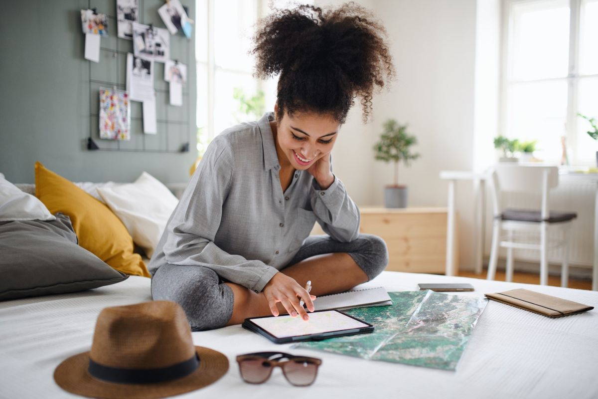 woman smiling holding pen and paper.