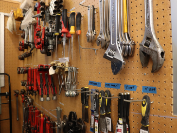 Peg board filled with wrenches and screwdrivers, etc.