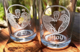 Photo of two glasses with the Cafe Ohlone logo on them on a wooden table