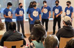 7 a capella singers from the NiCE group singing in the THPS community meeting room