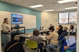classroom filled with adult learners watching presenter