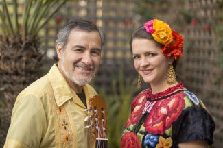 photo of Jorge and Arwen, members of Cascada de Flores, facing each other and smiling at the camera