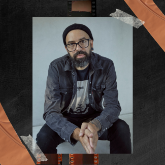 photo of James Spooner wearing a black beanie and grey shirt 