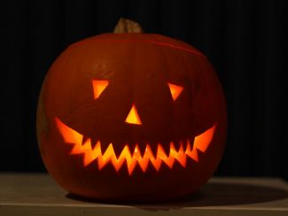 photo of a carved jack o'lantern pumpkin with a glowing light coming from within