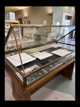 Archival photographs and text in a display case