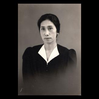Black and white photograph of a woman in formal attire