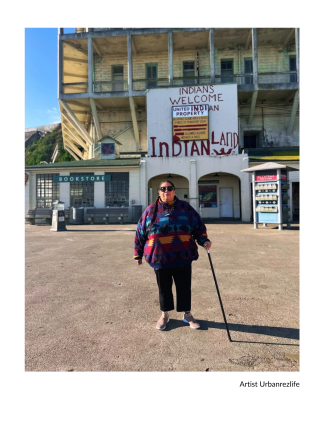 artist standing in front of building on alcatraz island