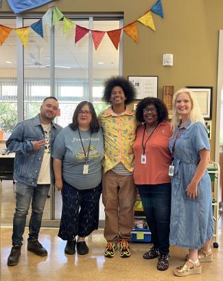 Four Library Staff on Filming Day Smiling with Mychal Threets