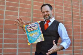 photo of Brian Scott doing a magic trick with a levitating book