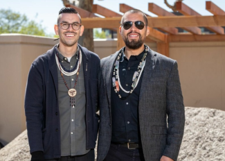 Photo of Cafe Ohlone founders Louis Trevino and Vincent Medina standing at the current Cafe Ohlone site, smiling
