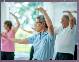 class of adults stretching with arms extended