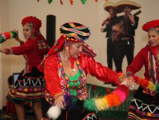 Hispanic women dancing in colorful dresses CC US Army Corps of Engineers: https://www.flickr.com/photos/savannahcorps/1535707786
