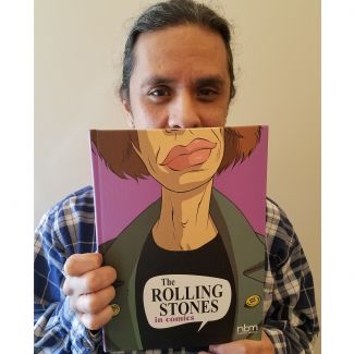 Person holding a book with the face of Mick Jagger as the cover.