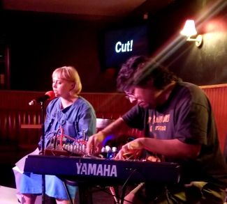 Lora and Matty performing poetry and music