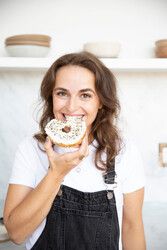 Micah Siva in the kitchen eating a bagel