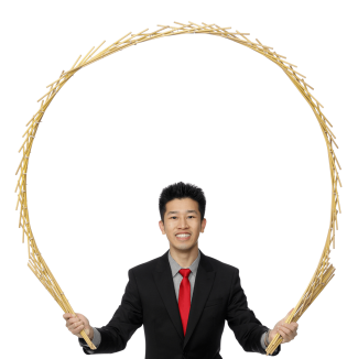 photo of magician Perry Yan holding up a magic prop