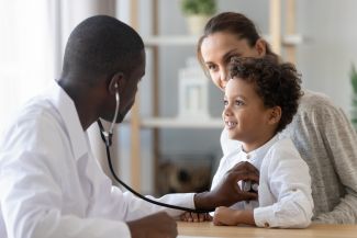 image of doctor examining child