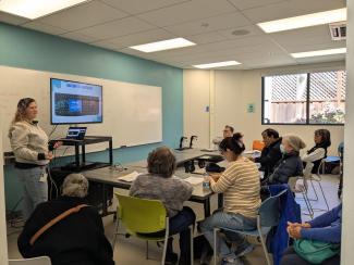 classroom filled with adult learners watching presenter