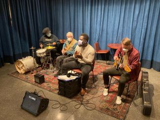 Four members of the Story Time Band playing instruments