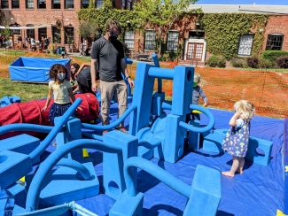 photo of kids playing outdoors with big blue blocks