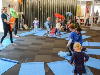 Children in fun exercise activity CC Tulsa City-County Library: https://www.flickr.com/photos/tulsalibrary/33482333671