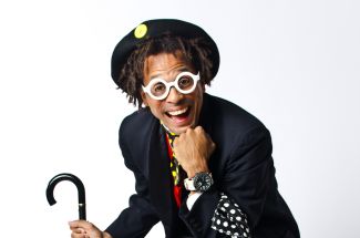 photo of Unique Derique with hat on head holding a cane