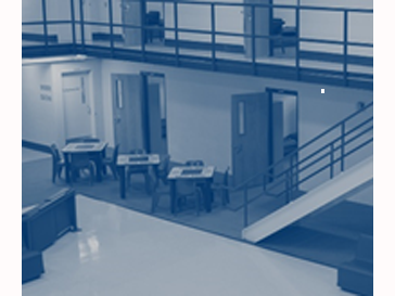 Interior view of detention facility with desks and stairway