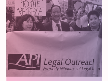 photograph of people marching behind a banner reading API Legal Outreach