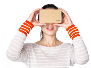 Woman holding a Google Cardboard Virtual Reality Headset
