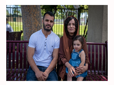 Two adults posing with a child