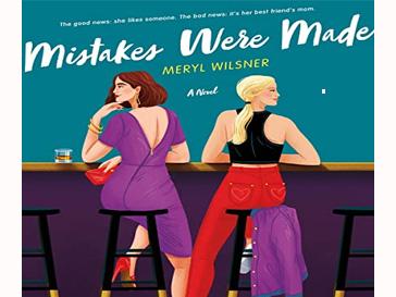 Two women sitting at a bar, as viewed from behind them.