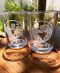 Photo of two glasses with the Cafe Ohlone logo on them on a wooden table